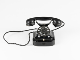 Isolated Vintage Black Rotary Dial Telephone with Curled Cord on White Background