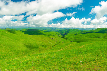 Beautiful landscape with low green hills in sunny weather. Caucasus
