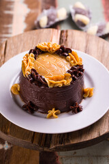 Delicious Chocolate Cake with Caramel Topping on Rustic Wooden Table