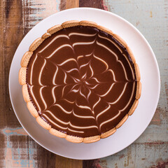 Delicious Chocolate Tart with Cookie Crust on Rustic Table
