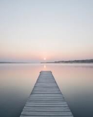 Sunrise over a Calm Lake with a Wooden Dock.