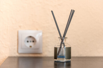 incense sticks in a jar with a fragrance on a bedside table in the room against the background of a...