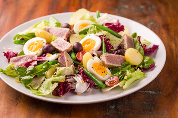 Fresh Nicoise Salad With Tuna, Eggs, and Vegetables on Plate