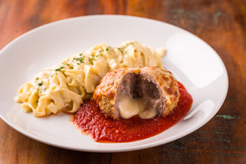 Delicious Meatball Stuffed With Cheese and Pasta on Rustic Plate