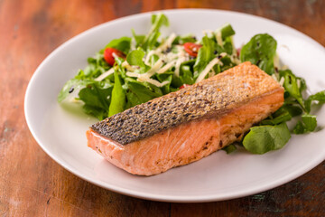 Grilled Salmon Fillet with Fresh Green Salad on Plate