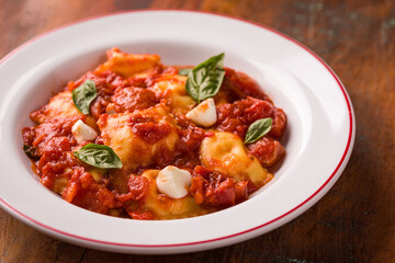 Delicious Homemade Ravioli With Tomato Sauce And Basil Leaves