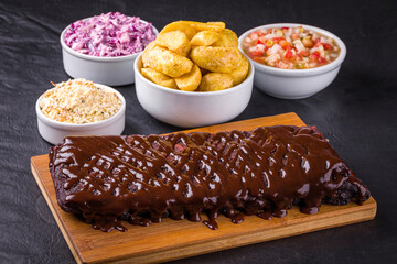 Delicious Barbecue Ribs with Sides on Wooden Platter