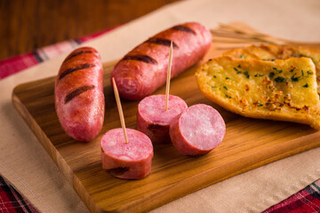 Delicious Grilled Sausage and Bread Platter on Wooden Board