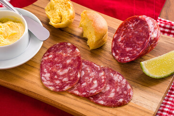 Italian Salami Platter with Butter and Bread on Wooden Board