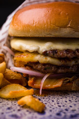 Delicious Cheeseburger and Fries on a Rustic Plate