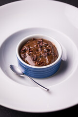 Indulgent Chocolate Dessert in a Blue Ramekin on White Plate