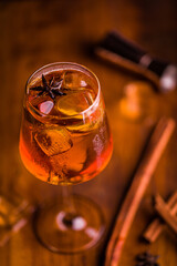 Elegant Cocktail With Star Anise and Cinnamon Garnish on Wooden Table