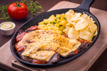 Delicious Cheesy Steak With Vegetables And Crispy Potato Chips In Skillet