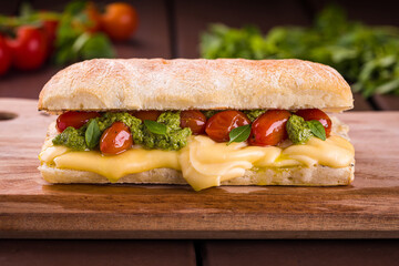 Delicious Gourmet Sandwich with Cheese, Pesto and Cherry Tomatoes