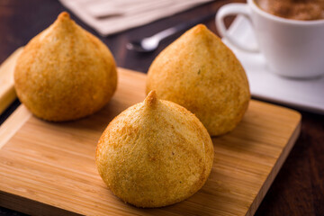Delicious Brazilian Coxinhas on Wooden Board with Coffee