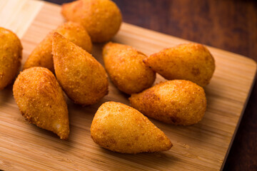 Golden Crispy Coxinha Delicacies on Wooden Platter
