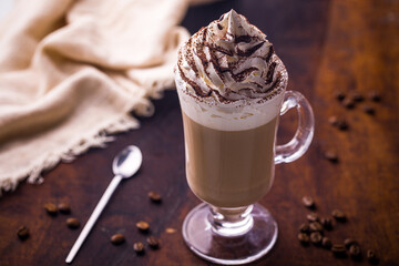 Delicious Coffee with Whipped Cream and Cocoa Topping on Rustic Table