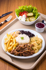 Delicious Brazilian Meal With Rice, Meat, Fries, and Vegetables