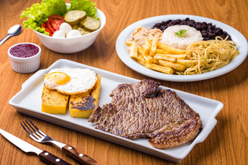 Delicious Traditional Brazilian Meal with Steak and Side Dishes