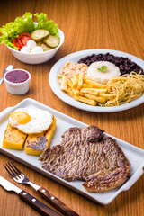 Delicious Brazilian Cuisine with Steak, Rice, and Vegetables