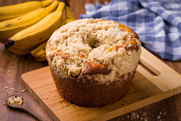 Freshly Baked Banana Bread With Crumble Topping On Wooden Board
