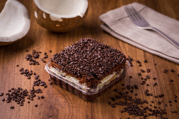 Delicious Chocolate Dessert With Coconut Topping on Wooden Table