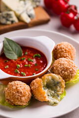 Delicious Arancini Cheese Balls with Tomato Dip and Fresh Ingredients