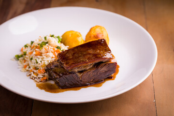 Gourmet Beef Dish with Rice and Vegetables on Elegant Plate