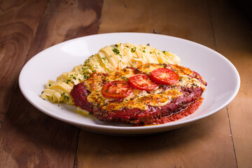 Delicious Chicken Parmesan With Pasta and Fresh Tomato Garnish