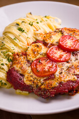 Delicious Chicken Parmigiana With Tagliatelle Pasta and Fresh Tomato
