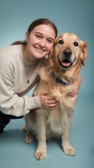 Smiling woman and relaxed golden retriever in soft portrait