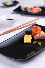 Elegant Sushi Presentation with Assorted Nigiri on Black Plate