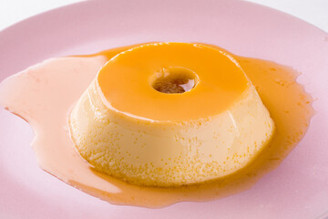 Delicious Caramel Flan on a Pink Plate with Syrup