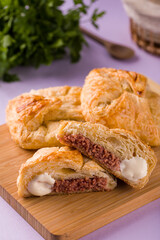 Delicious Buttery Pastries with Meat Filling on Wooden Board