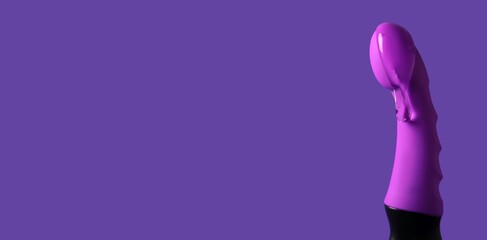 Vibrator covered with intimate lubricant on purple background with space for text, closeup