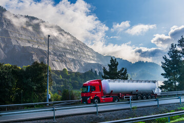 Truck with a tanker of powders descending a mountain pass.