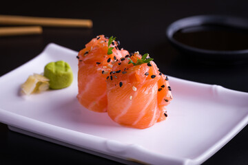 Freshly Prepared Salmon Sashimi Rolls with Wasabi and Soy Sauce