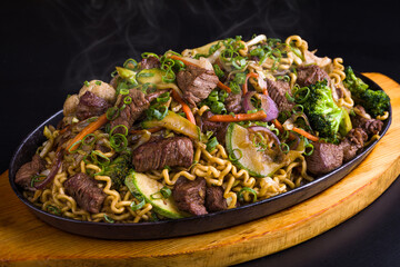 Delicious Yakisoba Stir-Fried Beef Noodles with Fresh Vegetables on Platter