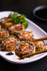 Close-Up of Crispy Sushi Roll with Soy Dipping Sauce