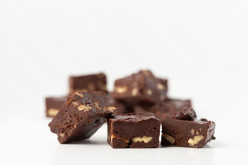 Close Up of Homemade Chocolate Pecan Fudge on a White Background