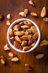 Top View of Bowl Filled With Raw Brazil Nuts on Wooden Table