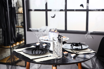 Interior of festive room with served table and decorations for Halloween party