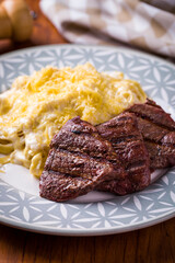 Delicious Grilled Mignon Steak with Creamy Pasta on Decorative Plate