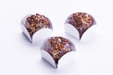 Three Chocolate Truffle Desserts in Elegant White Wrappers