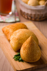 Delicious Brazilian Coxinha on a Wooden Cutting Board