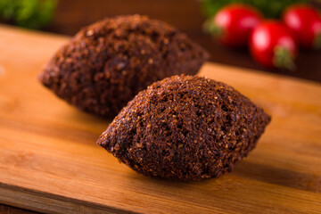 Delicious Lebanese Kibbeh on Wooden Cutting Board Background