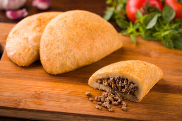 Delicious Empanadas with Savory Ground Beef Filling on Wood Board