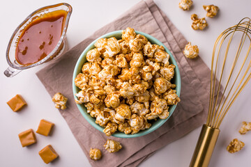 Delicious Caramel Popcorn in Bowl with Caramel Sauce and Snacks