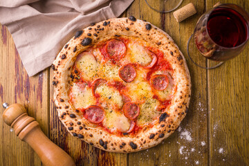 Delicious Pepperoni Pizza With Wine on Wooden Table