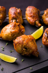 Delicious Grilled Chicken Drumsticks with Lime on Slate Plate